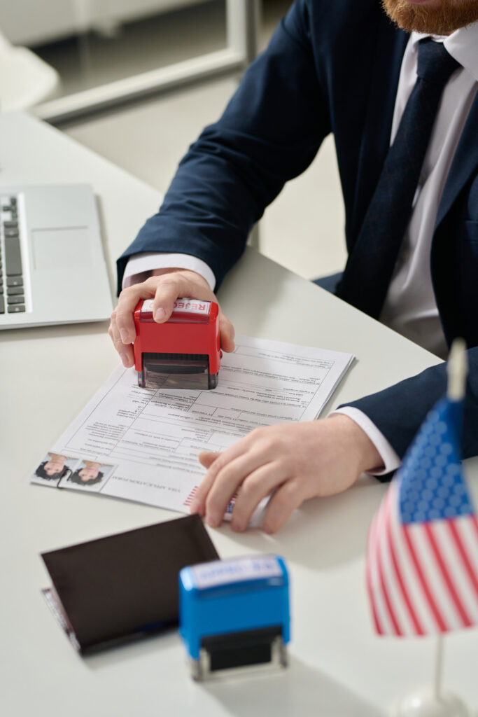 worker putting rejected stamp on visa application worker putting rejected stamp on visa application